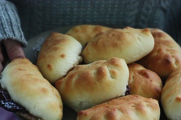 Delicious fresh pies with jam in hand 