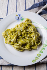 shirataki konjac noodles tagliatelle with genovese pesto and parmesan cheese. low carbs diet calories