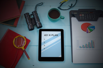 401K Plan text on tablet with cup of coffee, pen and smartphone.