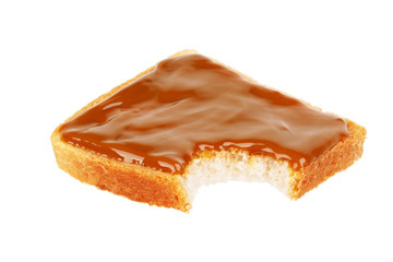 Bitten toast with condensed milk on a white background