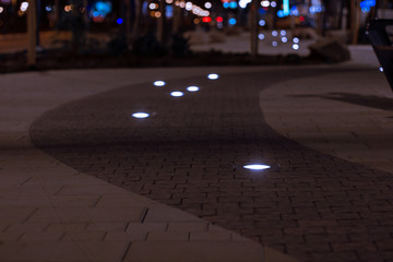 soft focus night city street perspective paved road surface with lamps decoration landscaping elements light