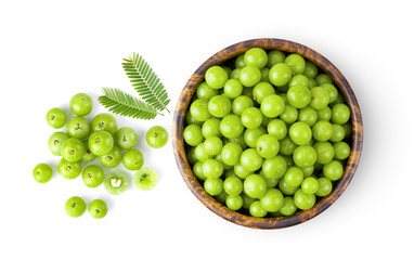 Indian gooseberry with leaf in wood bowl isolated on white background