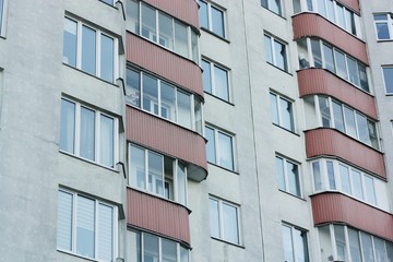 Red white house with windows close up view 