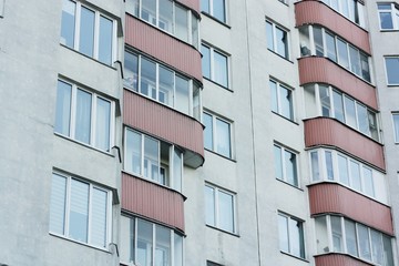 Red white house with windows close up view 