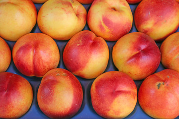 Row of Vibrant Red Organic Nectarine Fruits For Sale at the Market