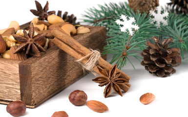 Wooden box with mixed nuts isolated on white.