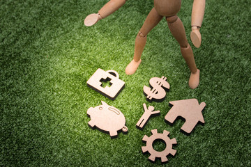 Naklejka premium Wood Figure Holding Wooden gear, house, money, bulb etc., Technology concept.