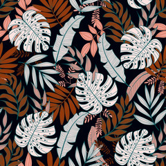 Colorful seamless pattern with tropical plants on dark background. Jungle leaves. Floral pattern. Vector background for various surface. Exotic wallpaper. Trendy summer print.