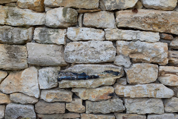 Limestone stone, masonry uneven pieces of sandstone, texture background backdrop