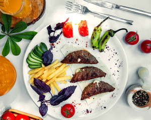 stuffed kebab with cheese, served with fries, grilled and fresh vegetables