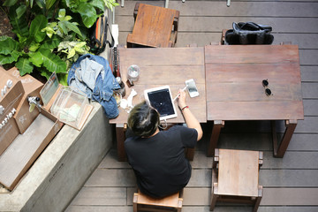 top view on people using tablet in cafe