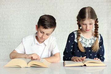 Portrait of diligent focused pupils studying in classroom at elementary school