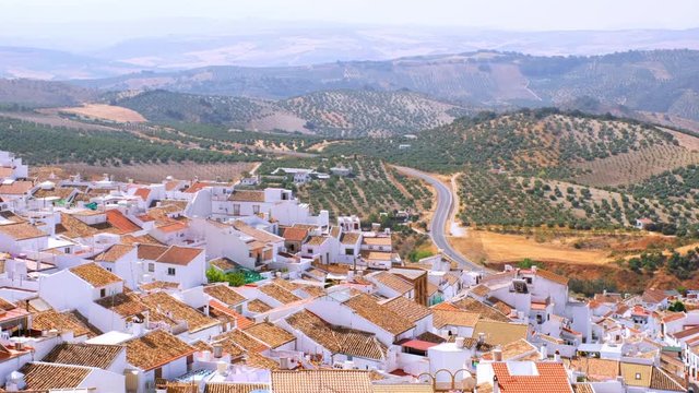 Olvera, Spain. Aerial view of old touristic town Olvera, Spain surrounded by mountains. Dry landscape in hot summer, White houses in Spanish village. Zoom out