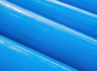 Stack of new blue pipes (tubes)