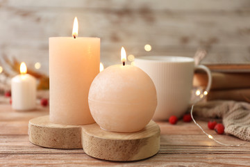Glowing candles on wooden table
