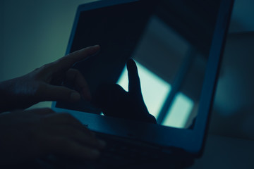 Black hands of anonymous hackers  typing code on keyboard of laptop for remotely reach, receiving personal information online, Networking Crime Payment Security Concept