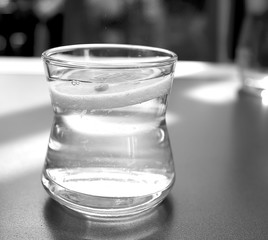 a glass of lemonade stands on a table in a restaurant