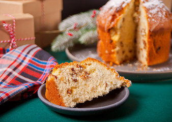 Traditional Christmas cake panettone with fruits and nuts with Christmas decoration