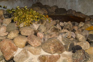 Masonry with an iron barrel for heating water in a Russian traditional bathhouse.