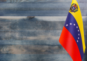 Fragment of the flag of Venezuela in the foreground blurred light background copy space