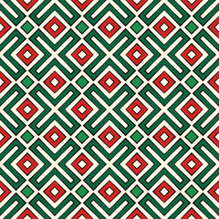 Seamless pattern in Christmas colors. Ethnic and tribal motif. Repeated geometric forms. Colorful ornamental background