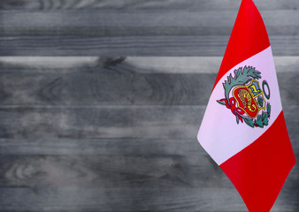 Fragment of the flag of Peru in the foreground blurred light background copy space