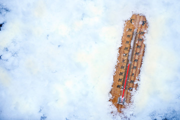 Thermometer in snow shows low temperatures