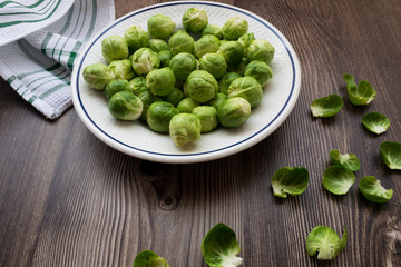 Organic and natural Brussels sprouts on a plate with a wooden table