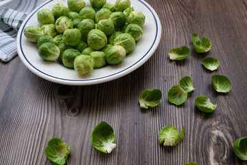 organic brussel sprouts in a plate on a wooden table