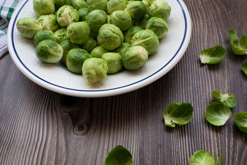 close-up of fresh brussel sprouts on a plate with a wooden table