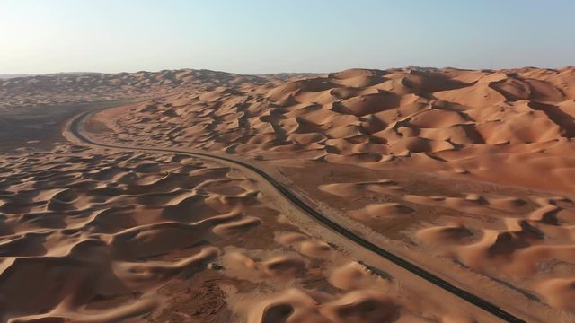 Aerial shot of empty road in desert dunes. Liwa desert, Abu-Dhabi, UAE