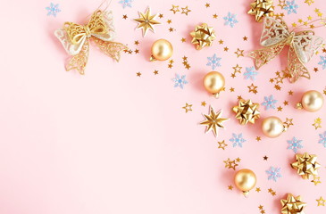 Christmas background. Xmas or new year gold blue color decorations on pastel pink background with empty copy space for text.  holiday and celebration concept for postcard or invitation. top view 