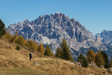 Fototapeta na wymiar Photographer shooting mountains in the Italian Dolomites in sunny weather
