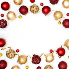 New Year and Christmas frame. Red and golden Christmas decorations - shiny balls and decorative ribbon on white paper background. Top view, flat lay, copy space