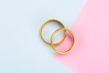 Minimalist pastel color paper layout with Golden girl accessories on pink and blue 