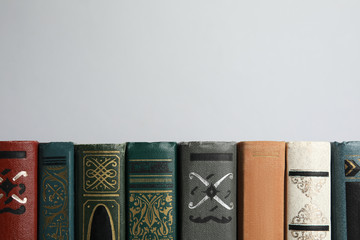 Collection of old books on light background, space for text
