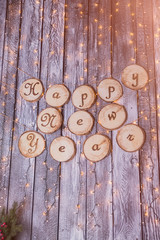 happy new year text in snow and retro style on a white wooden background. Winter or Christmas festive concept.