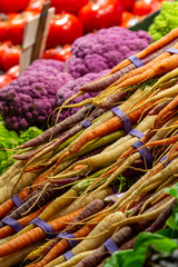 A selection of colourful vegetables for sale on a farmers market stall