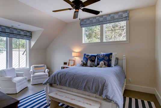 Beautiful upstairs spare bedroom with neutral colors and windows.