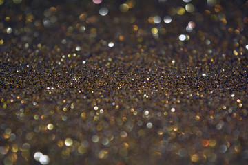 Beautiful Abstract Sparkle Glitter Lights Background. Gold Champagne. Dark Gray Deep Blue Black. Shine Bokeh Effect. For party, holidays, celebration.
