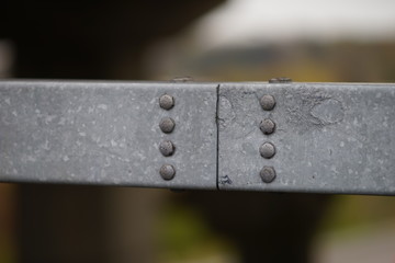 Close up bolt caps on steel structure.