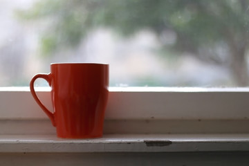 Cup of tea by the rustic window. Selective focus.
