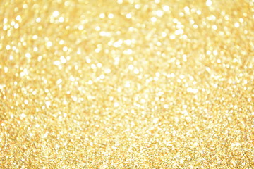Beautiful Abstract Sparkle Glitter Lights Background. Gold Champagne. Shine Bokeh Effect. For party, holidays, celebration.
