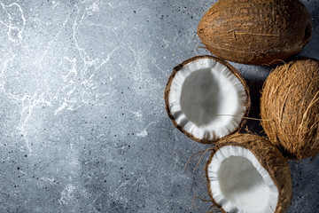 Fototapeta na wymiar ripe chopped coconut on a gray stone background. place for your text