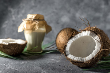 Obraz na płótnie Canvas ripe chopped coconut on a gray stone background Coconut oil.