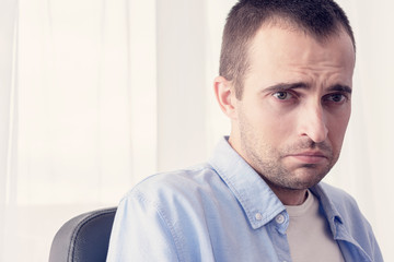 Obraz premium Sad man is depressed, in his life a lot of stress, portrait, close up, toned