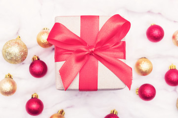 Christmas toys and gift with red ribbon, white snow made of cotton, closeup, top view