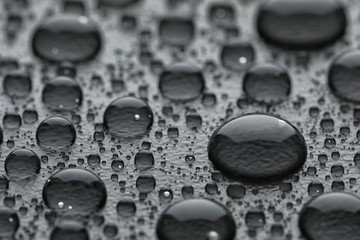 Water drops on grey background, closeup view