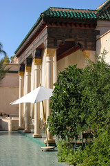 Entrance with pillars in the secret jardin (garden), Marrakech, Morocco. With beautiful golden decorations.