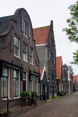 Fototapeta na wymiar View of historical, traditional and typical houses in Edam. It is a town famous for its semi hard cheese in the northwest Netherlands, in the province of North Holland.